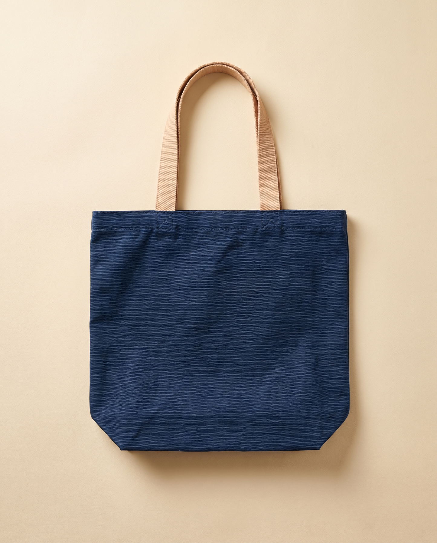 Navy canvas tote bag with natural webbing handles