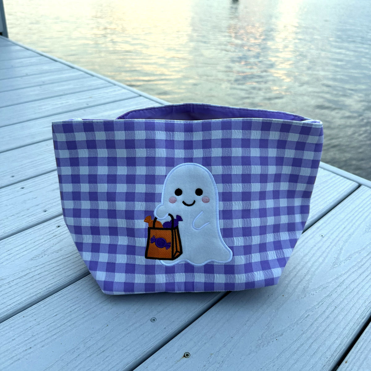 Purple gingham basket with a white ghost holding a candy bag
